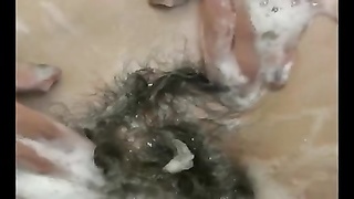 nice wooly lady gets off in the shower with shower head 